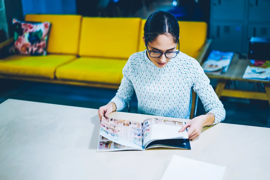 Buyer reviewing a printed catalogue at an office table